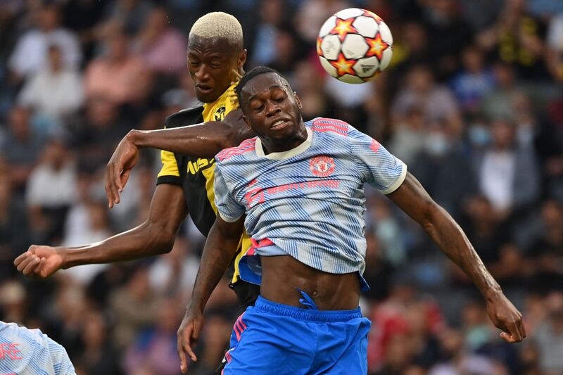 United's Aaron Wan-Bissaka and Mohamed Ali Camara of Young Boys challenge for a header. AFP