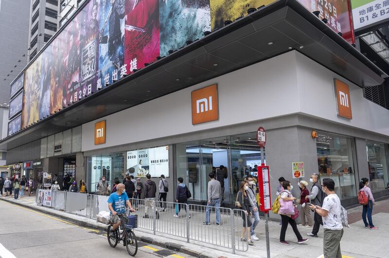 Pedestrians walk past a Xiaomi Corp. store in Hong Kong, China, on Saturday, March 6, 2021. Beijing's increasing grip over Hong Kong has done more than snuff out democracy advocates: It's also led to fluid changes in the city's physical landscape. Photographer: Justin Chin/Bloomberg