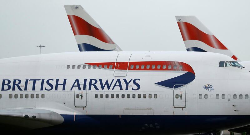 FILE - This Jan. 10, 2017 file photo, British Airways planes are parked at Heathrow Airport in London.  British Airways said Wednesday Aug. 7, 2019, it has canceled some dozens of flights from London airports after its check-in systems were hit by a computer glitch.(AP Photo/Frank Augstein, File)