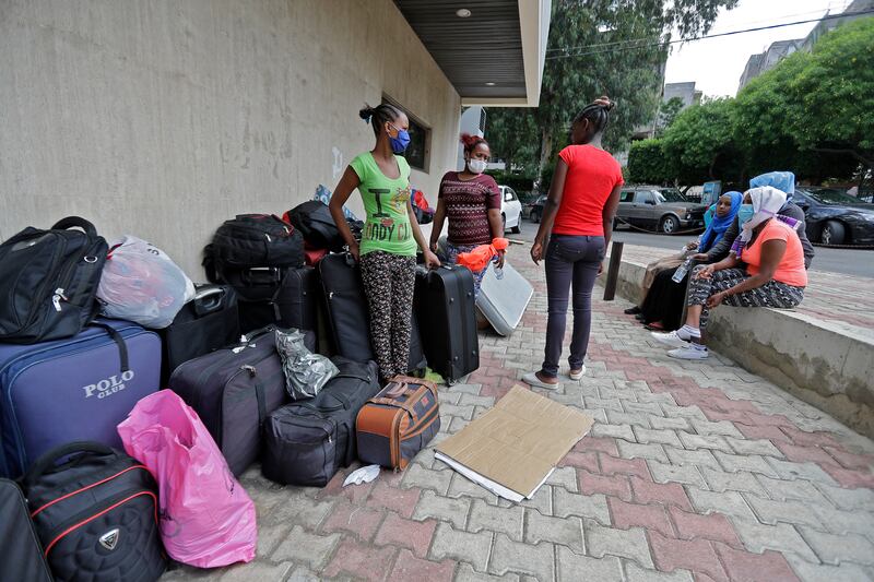 Ethiopian domestic workers who were dismissed by their employers gather with their belongings outside their country's embassy in Hazmiyeh, east of Beirut. AFP