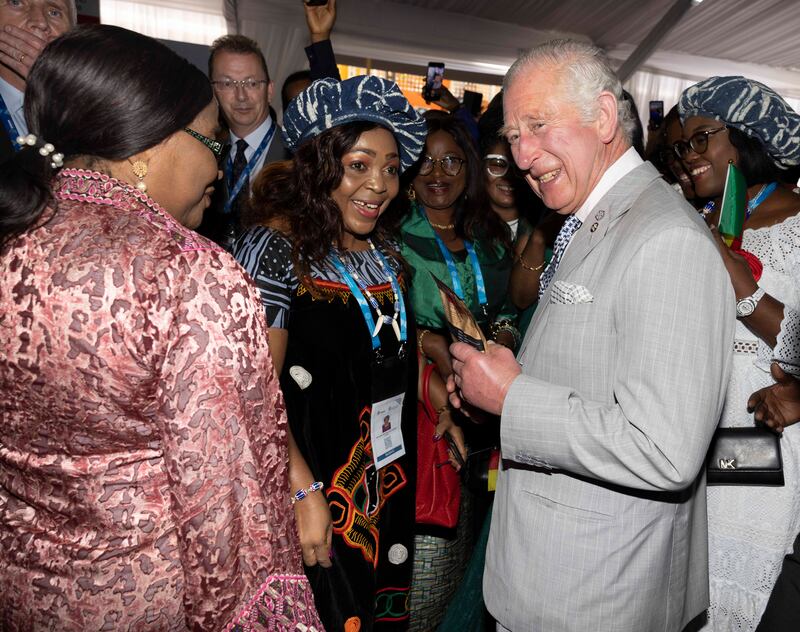 Prince Charles speaks with guests while attending the Business Forum Exhibition at the Kigali Cultural Village. Getty Images