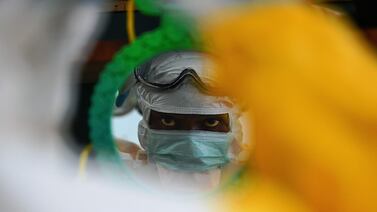 A medic works in an isolation unit during an Ebola scare in Guinea. Health authorities in the country have now reported a case of the deadly Marburg virus. AFP