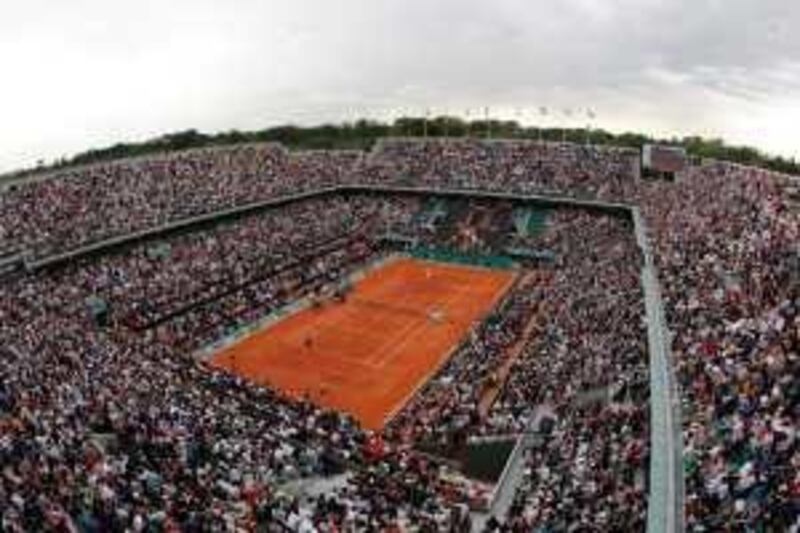 The crowd watches an exhibition match on Philippe Chatrier court, known as center court, at the Roland Garros stadium in Paris, Saturday May 23, 2009, on the eve of the French Open tennis tournament. (AP Photo/Christophe Ena)