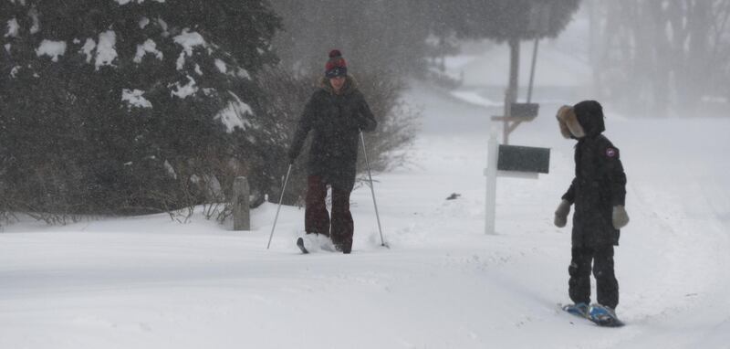 A woman gets by on cross-country skis in Wrentham, Massachusetts. Matt Campbell / EPA