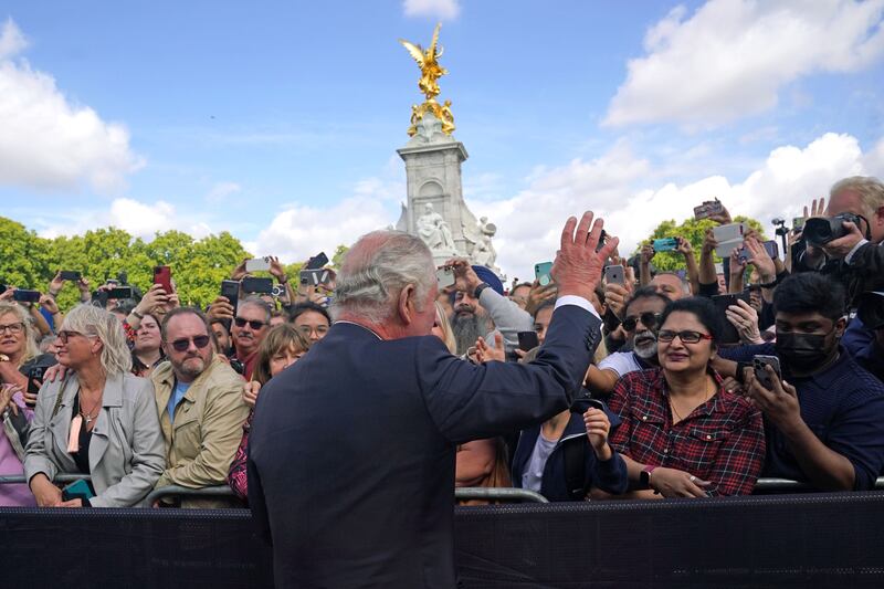 King Charles during a walkabout to view tributes left outside Buckingham Palace. PA