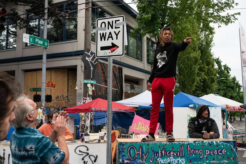 An organiser rallies protesters in the Capitol Hill Organised Protest area on Monday in Seattle. Getty Images/AFP