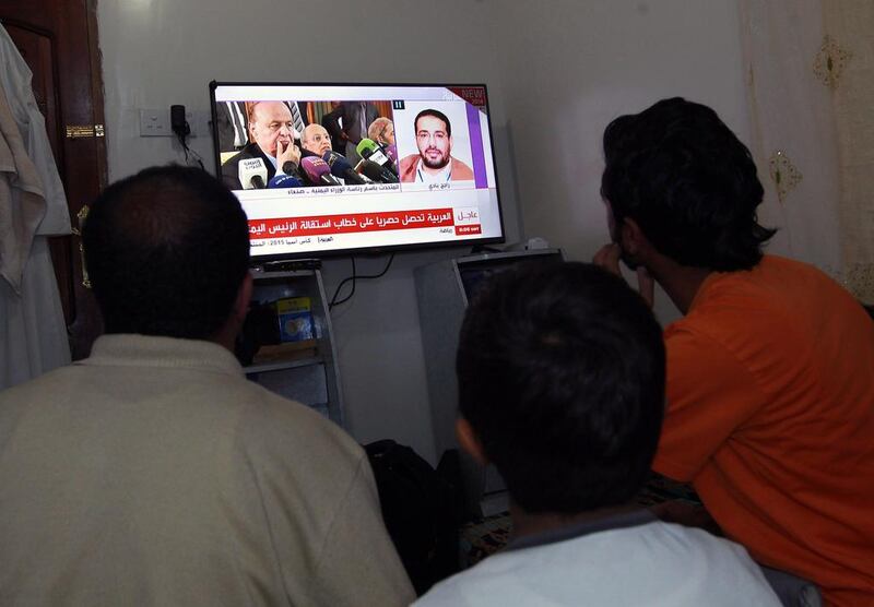 Yemenis watch the news in Sanaa on January 22, 2015, after President Abdrabu Mansur Hadi and the government tendered their resignations. Mohammed Huwais / AFP