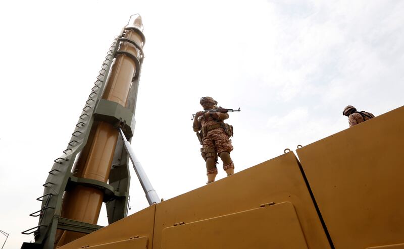 An Iranian soldier stands next to a Shahab-3 missile in Tehran. EPA