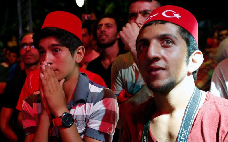 Turks react after finding out that Tokyo was awarded the right to host the 2020 Summer Games as they watch it live on big screens in Sultanahmet Square in Istanbul September 7, 2013.  REUTERS/Murad Sezer (TURKEY - Tags: SPORT OLYMPICS) *** Local Caption ***  IST01_OLYMPICS-2020_0907_11.JPG