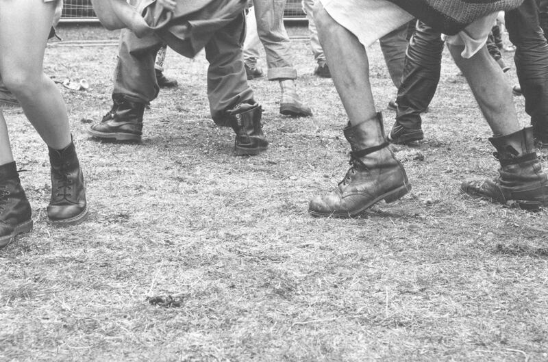 People wearing Dr Marten boots dancing at the Deptford Free Festival in south London, July 1993. (Photo by Steve Eason/Hulton Archive/Getty Images)