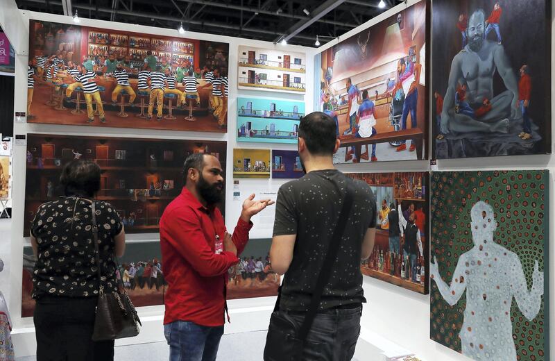 DUBAI , UNITED ARAB EMIRATES , April 3 – 2019 :-  Visitors looking at the art works which are on display at the World Art Dubai 2019 held at Dubai World Trade Centre from 3rd to 6th April in Dubai. ( Pawan Singh / The National ) For News/Online/Instagram