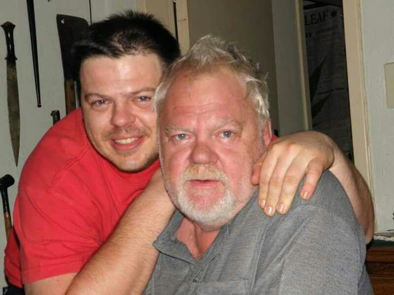 Scott Matthews (seen here with his father), a 29-year-old from Pretoria who had been working as a restaurant manager, was admitted to hospital in late July with multiple organ failure. Courtesy Mignon Matthews
