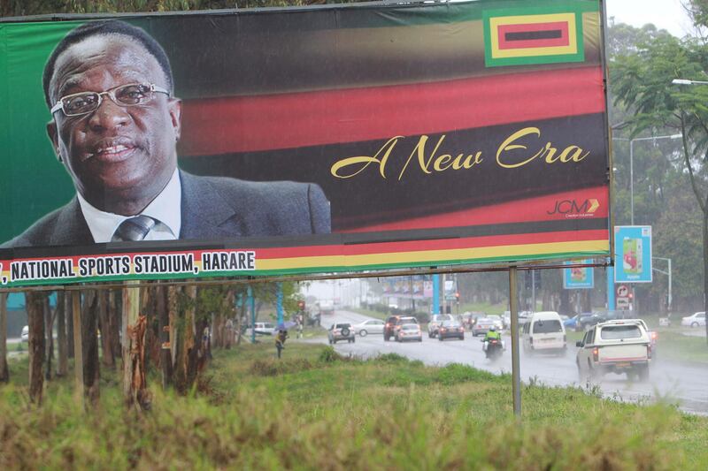 Traffic flows past a billboard with a portrait of  Emmerson Mnangagwa the new Zimbabwean President  in Harare, Zimbabwe, Monday, Nov.27, 2017. Zimbabwe's security forces said in a joint statement Monday that the "situation in our country had returned to normalcy", after a crisis during which the military staged a takeover and crowds demonstrated against Mugabe at the end of his 37 year rule.(AP Photo/Tsvangirayi Mukwazhi)