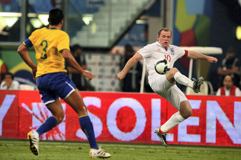 England?s Wayne Rooney, right, and Brazilian player Lucimar da  Silva in action during the friendly international soccer match in Doha, Qatar on Saturday  Nov 14, 2009. (AP Photo/Hanson K. Joseph)