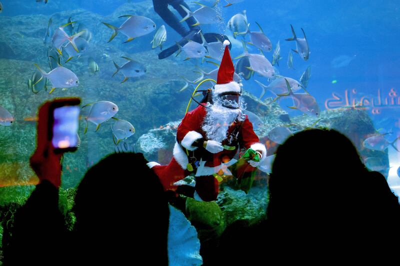 A diver dressed as Santa Claus greets visitors at the Dubai Mall aquarium. AFP