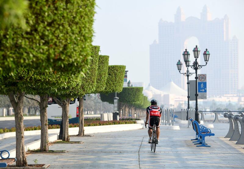 Morning-AD  Residents cycle during low visibility along the Corniche, in Abu Dhabi on June 5, 2021. Khushnum Bhandari / The National 
Reporter: N/A News
