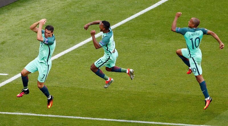 Portugal's Cristiano Ronaldo, left, celebrates with Nani and Joao Mario after scoring their second goal against Hungary. REUTERS/Max Rossi