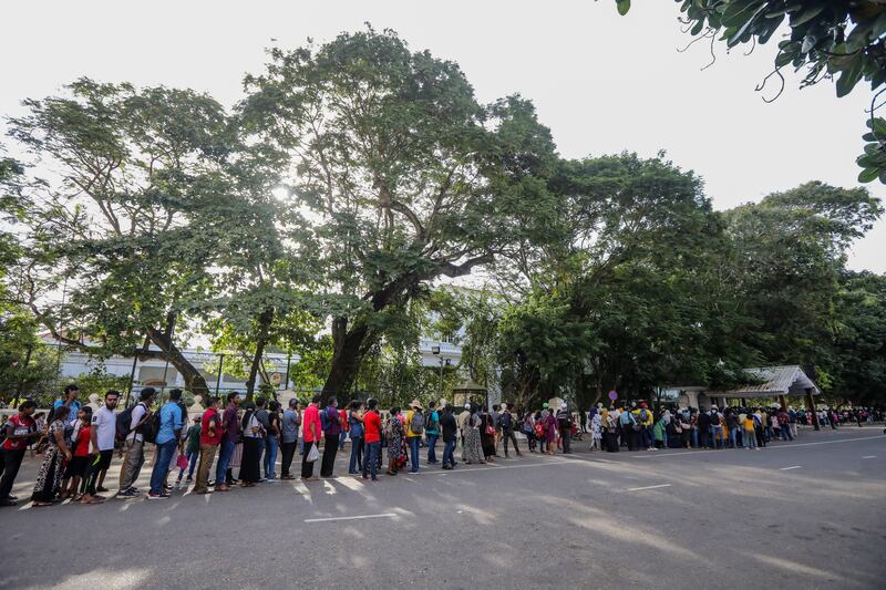 Sri Lankans line up to take a look inside the presidential palace in Colombo. EPA