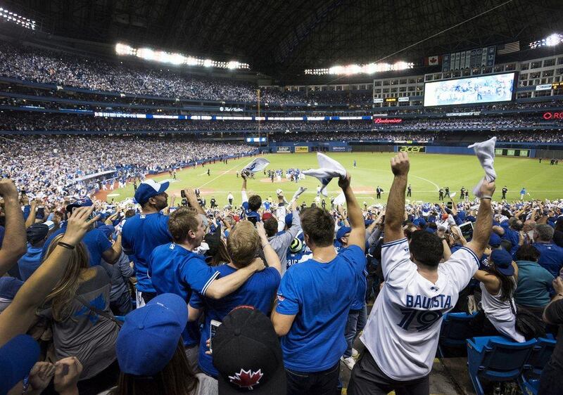 Fans celebrate following the Toronto Blue Jays defeating the Texas Rangers and advancing to the American League Championship Series on Wednesday night. Darren Calabrese / The Canadian Press / AP