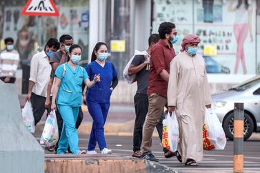 Residents wear face masks to prevent the spread of Covid-19 in Abu Dhabi. Victor Besa / The National 