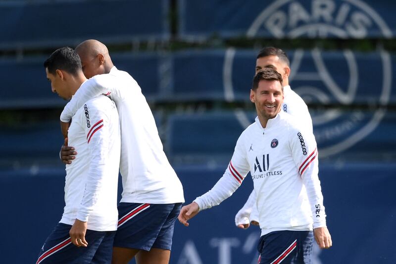 Lionel Messi (R) takes part in a training session at the Camp des Loges. AFP