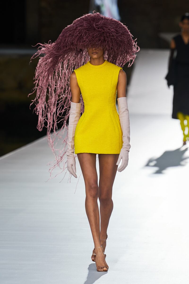 A Philip Treacy ostrich feather hat appeared with a tailored micro dress, at Valentino autumn 2021 haute couture