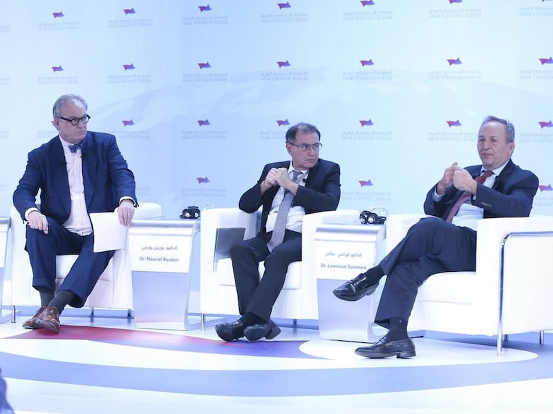 Larry Summers (right), former treasury secretary and director of the National Economic Council, speaks at the Arab Strategy Forum in Dubai as Nouriel Roubini,

economist, (centre) looks on with Tom Keene of Bloomberg Business, left.. Ihsan Naji / Al Ittihad