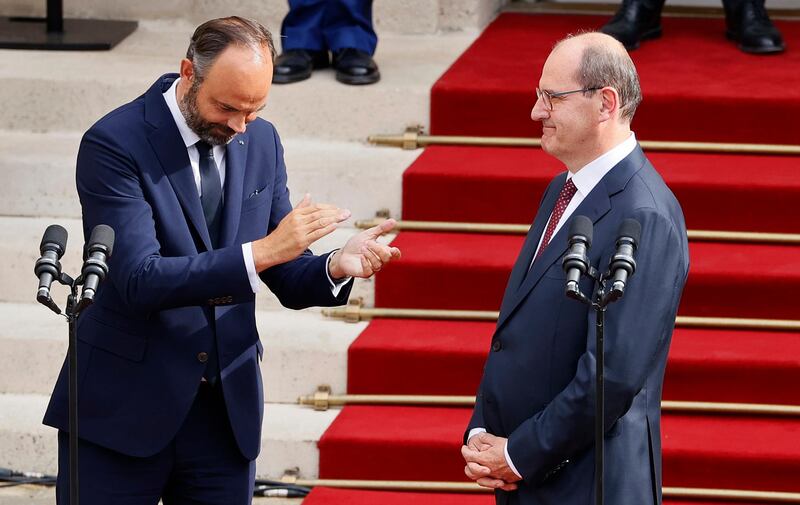 Outgoing French Prime Minister Edouard Philippe, left, applauds newly named Prime Minister Jean Castex, after the handover ceremony in Paris on July 3. AP