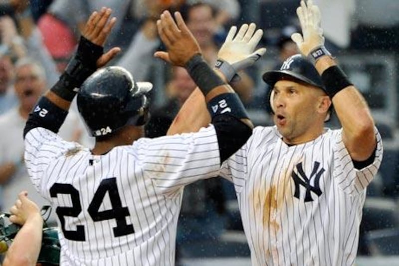 New York Yankees' Raul Ibanez, right, celebrates with Robinson Cano.