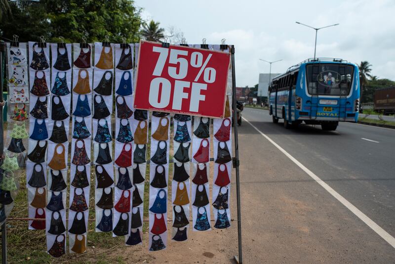 Face masks are displayed for sale by the side of a highway in Kochi, Kerala state, India. AP