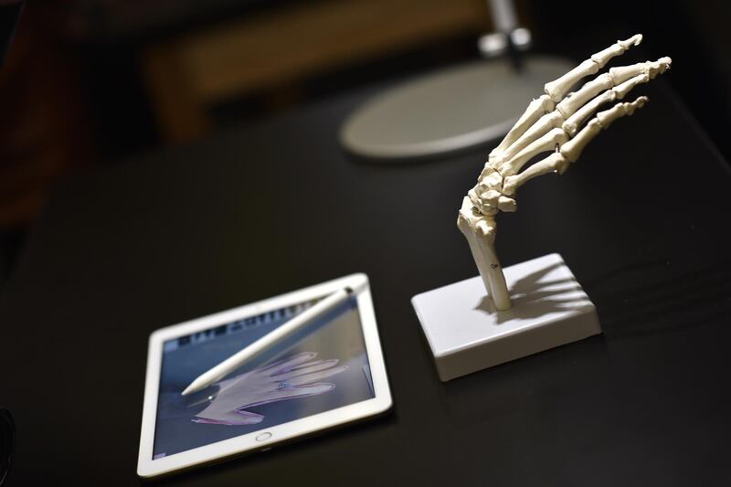 A new Apple iPad and Apple Pencil accessory displayed next to a model skeleton hand in a technology lab during an event at Lane Technical College Prep High School in Chicago, Illinois. Christopher Dilts / Bloomberg