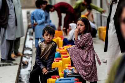 Afghan children wait to fetch drinking water at a mosque in Dasht-e-Barchi, Kabul. AFP