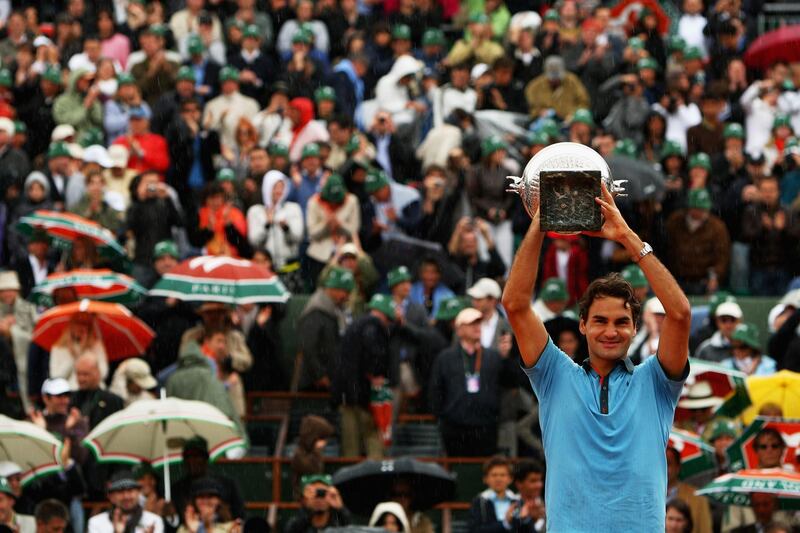 PARIS - JUNE 07:  Roger Federer of Switzerland lifts the trophy as he celebrates victory during the Men's Singles Final match against Robin Soderling of Sweden on day fifteen of the French Open at Roland Garros on June 7, 2009 in Paris, France.  (Photo by Clive Brunskill/Getty Images)