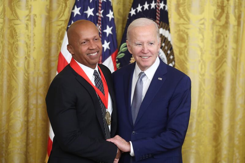 Mr Biden presents lawyer, activist and author Bryan Stevenson with the National Humanities Medal. EPA