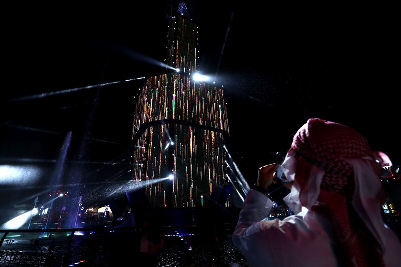 A visitors admires the Emirates Fountain lightshow, which features water spurting from 600 nozzles