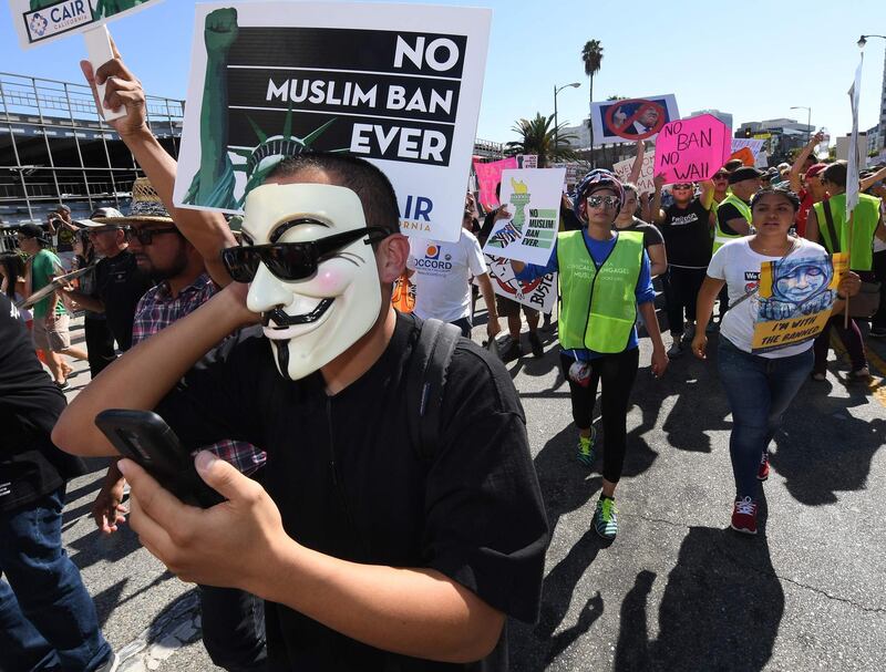 People march as they participate in the '#NoMuslimBanEver' rally in downtown Los Angeles, California on October 15, 2017. 
The march organized by the Council on American-Islamic Relations was in response to President Donald Trump's most recent travel ban. / AFP PHOTO / Mark RALSTON