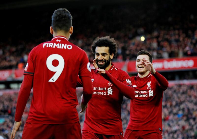 Soccer Football - Premier League - Liverpool v AFC Bournemouth - Anfield, Liverpool, Britain - February 9, 2019  Liverpool's Mohamed Salah celebrates scoring their third goal with Roberto Firmino and Andrew Robertson            REUTERS/Phil Noble  EDITORIAL USE ONLY. No use with unauthorized audio, video, data, fixture lists, club/league logos or "live" services. Online in-match use limited to 75 images, no video emulation. No use in betting, games or single club/league/player publications.  Please contact your account representative for further details.
