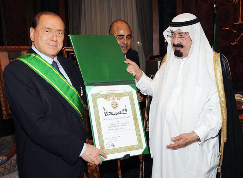 The late Saudi King Abdullah bin Abdul Aziz decorates Mr Berlusconi with the King Abdul Aziz medal during a meeting in Jeddah in November 2009. AFP