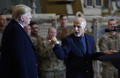 (FILES) In this file photo Afghan's President Ashraf Ghani addresses US troops during a surprise Thanksgiving day visit of US President Donald Trump at Bagram Air Field, on November 28, 2019 in Afghanistan. The US will cut its troops in Afghanistan to 2,500 in January, the lowest level in nearly two decades of war, as outgoing President Donald Trump follows through on a pledge to end conflicts abroad, the Pentagon announced on November 17, 2020. Acting Defense Secretary Chris Miller said around 2,000 troops would be pulled from the country by January 15, and 500 more would come back from Iraq, leaving 2,500 in each country.
 / AFP / Olivier Douliery

