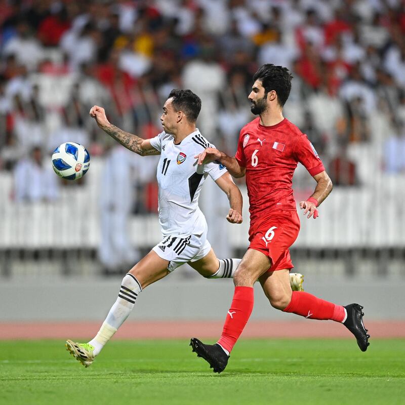 UAE's Caio Canedo, left, takes the game to Bahrain. Photo: UAE FA