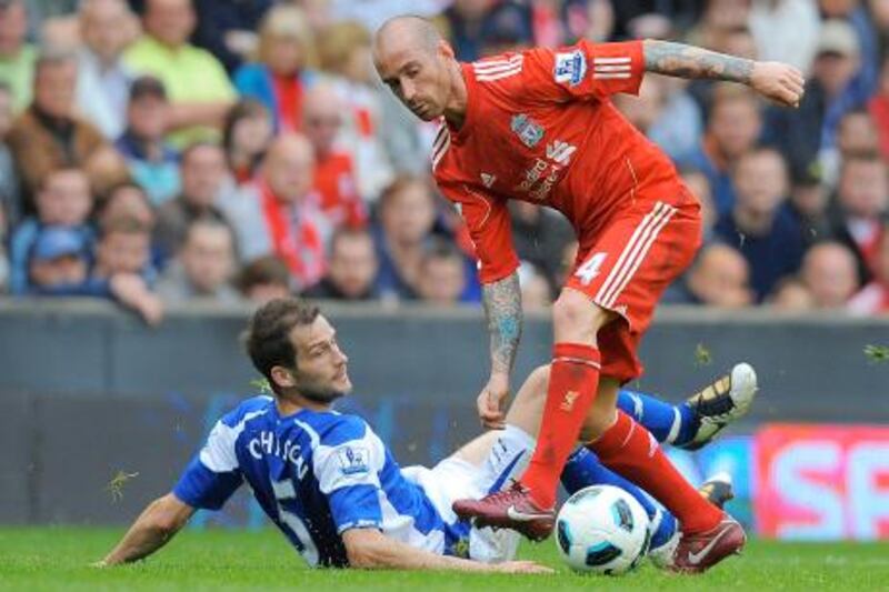 Liverpool's Portuguese midfielder Raul Meireles (R) vies with Birmingham City's English defender Roger Johnson (L) during the English Premier League football match between Liverpool and Birmingham City at Anfield in Liverpool, north-west England on April 23, 2011. AFP PHOTO/ANDREW YATES

FOR EDITORIAL USE ONLY Additional licence required for any commercial/promotional use or use on TV or internet (except identical online version of newspaper) of Premier League/Football League photos. Tel DataCo +44 207 2981656. Do not alter/modify photo.