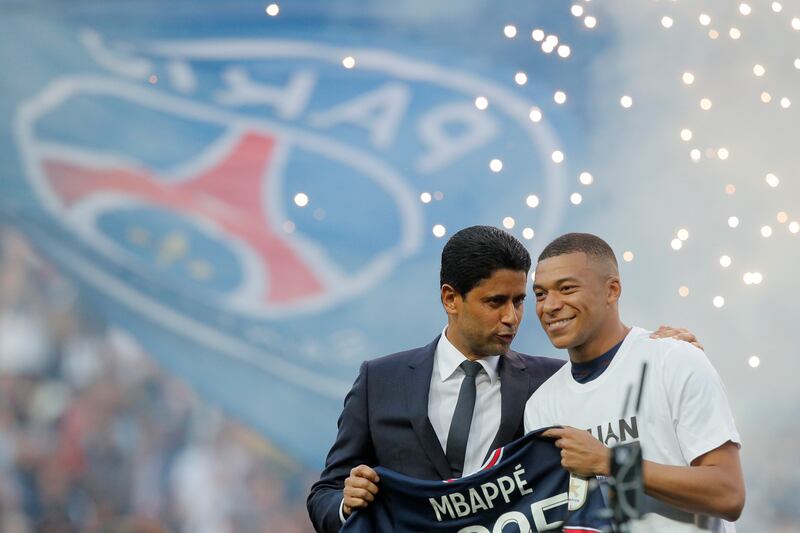 PSG President Nasser Al-Khelaifi speaks to Kylian Mbappe as they announce the France forward has signed a new deal. AP