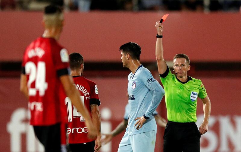 Atletico Madrid's Alvaro Morata is shown a red card by referee Alejandro Hernandez. Reuters
