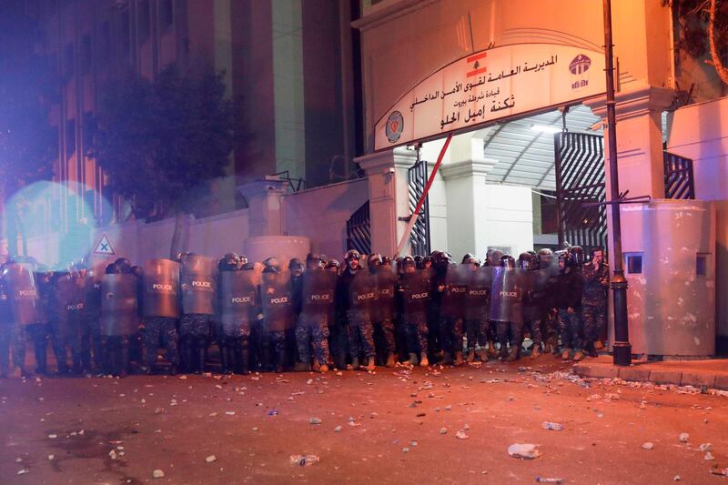 Riot police gather outside barracks during clashes with Lebanese anti-government protesters. AFP
