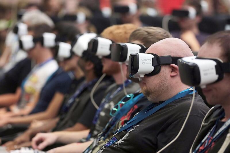 Trade visitors wear VR goggles by Samsung to take a rollercoaster ride at the game fair Gamescom in Cologne, western Germany, on August 17, 2016. The fair runs from August 17 to 21, 2016. 

 - Germany OUT

 / AFP / dpa / Oliver Berg