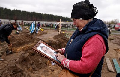 Natalia Maznichenko holds a photograph of her husband, Vasyl Maznichenko, who was killed when Russians shelled their home in Bucha, north-west of Kyiv. Reuters 