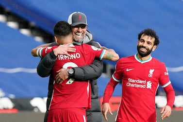 Jurgen Klopp, seen hugging Roberto Firmino, has won the Premier League and Champions League while in charge of Liverpool. AP