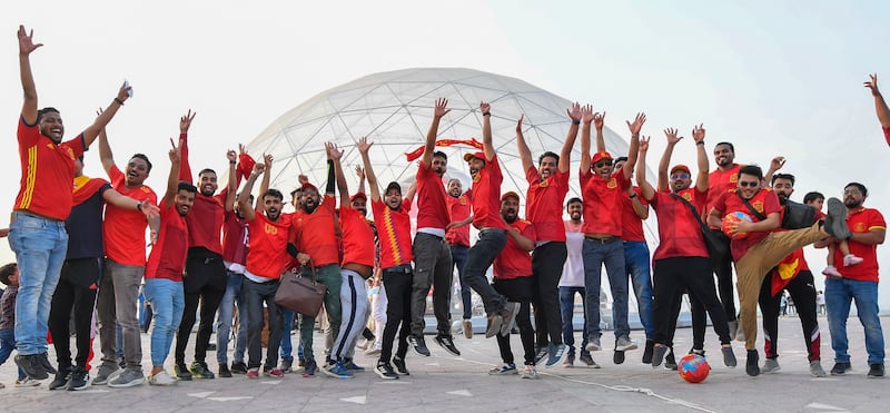 Qatari football fans jump for joy.