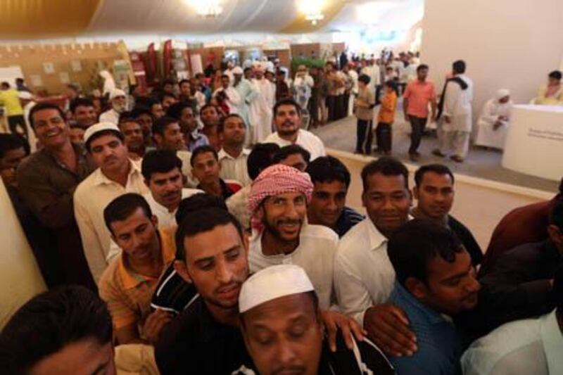 July 25, 2013 (Abu Dhabi) Crowds of people wait in line to get a gift bag from the Liwa Date Festival in Liwa July 25, 2013. (Sammy Dallal / The National) 