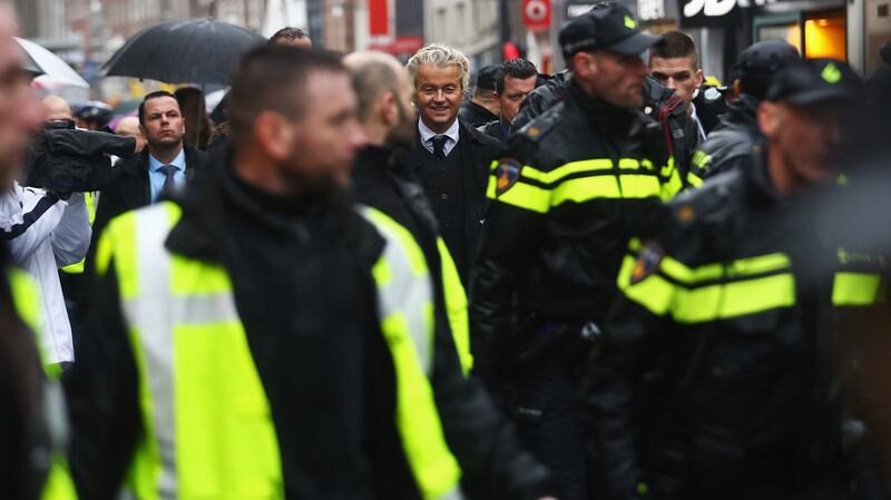 Mr Wilders with a police guard during his election campaign in Breda, Netherlands, in 2017. Getty Images